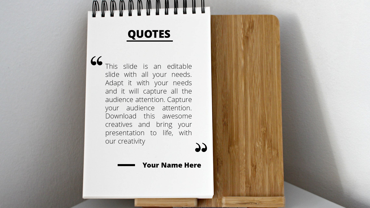 Quote slide with a spiral notebook design placed on a wooden stand, featuring text and a clean layout.