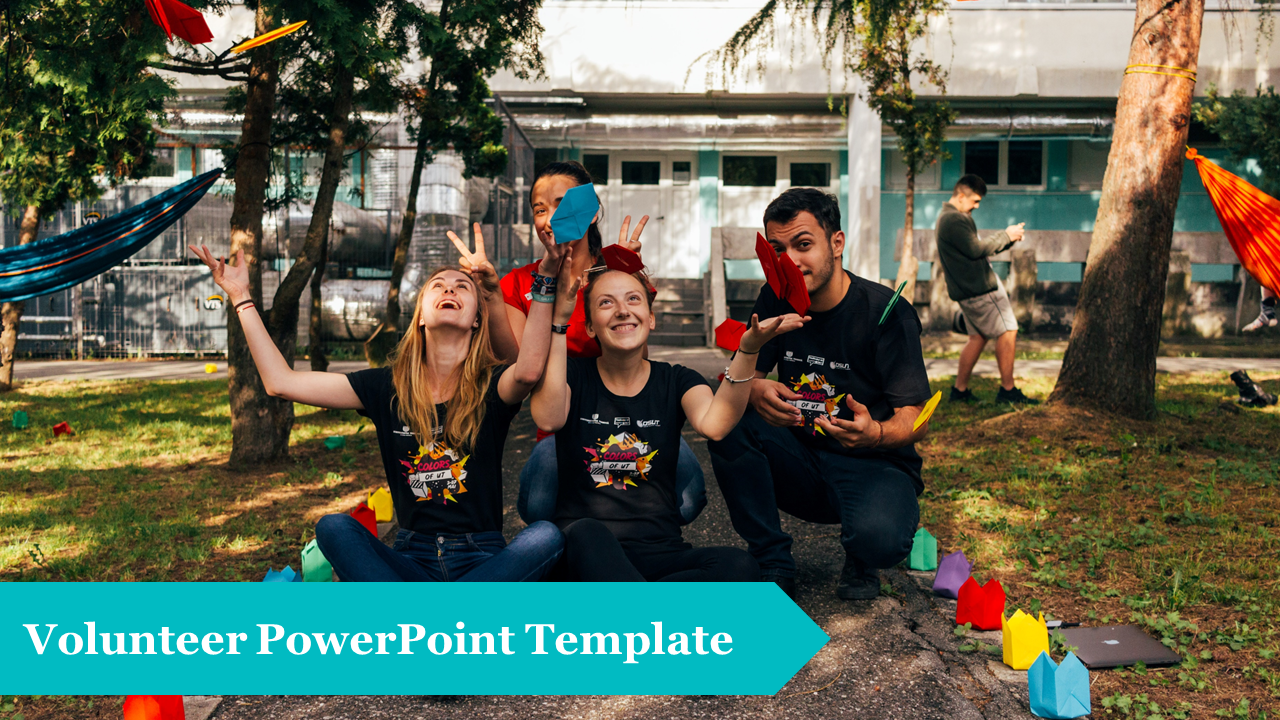 Volunteers in a park throwing colorful paper creations, with a teal ext overlay at the bottom.