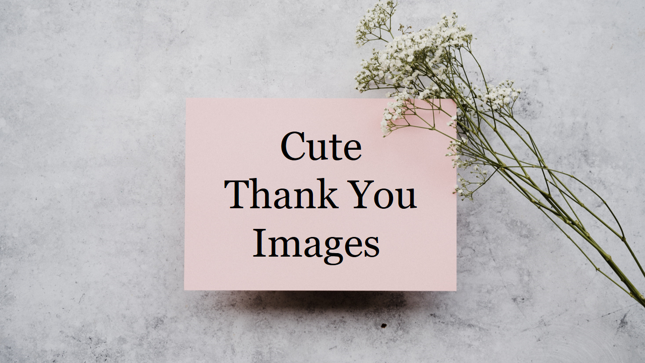 Pink card with the text area for a cute thank you message placed on a gray surface with a sprig of small white flowers.