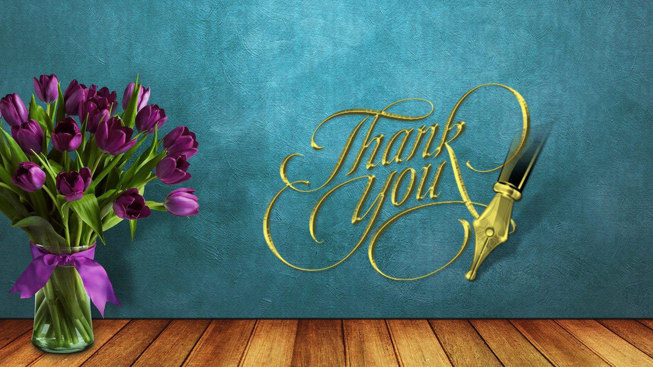 Thanks note in gold cursive writing with a pen nib next to a vase of purple tulips on textured background and wooden floor.