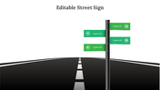 Black signpost with four green directional signs on a straight road with white dashed lines heading forward.