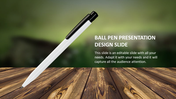 A white pen with a black clip placed diagonally on a wooden surface, against a blurred green background.