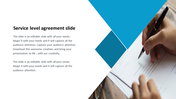 Service level agreement slide with text on the left and an image of a hand signing a document on the right.