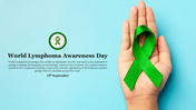 World lymphoma awareness day slide with a green ribbon in a hand, symbolizing support, on a light blue background.